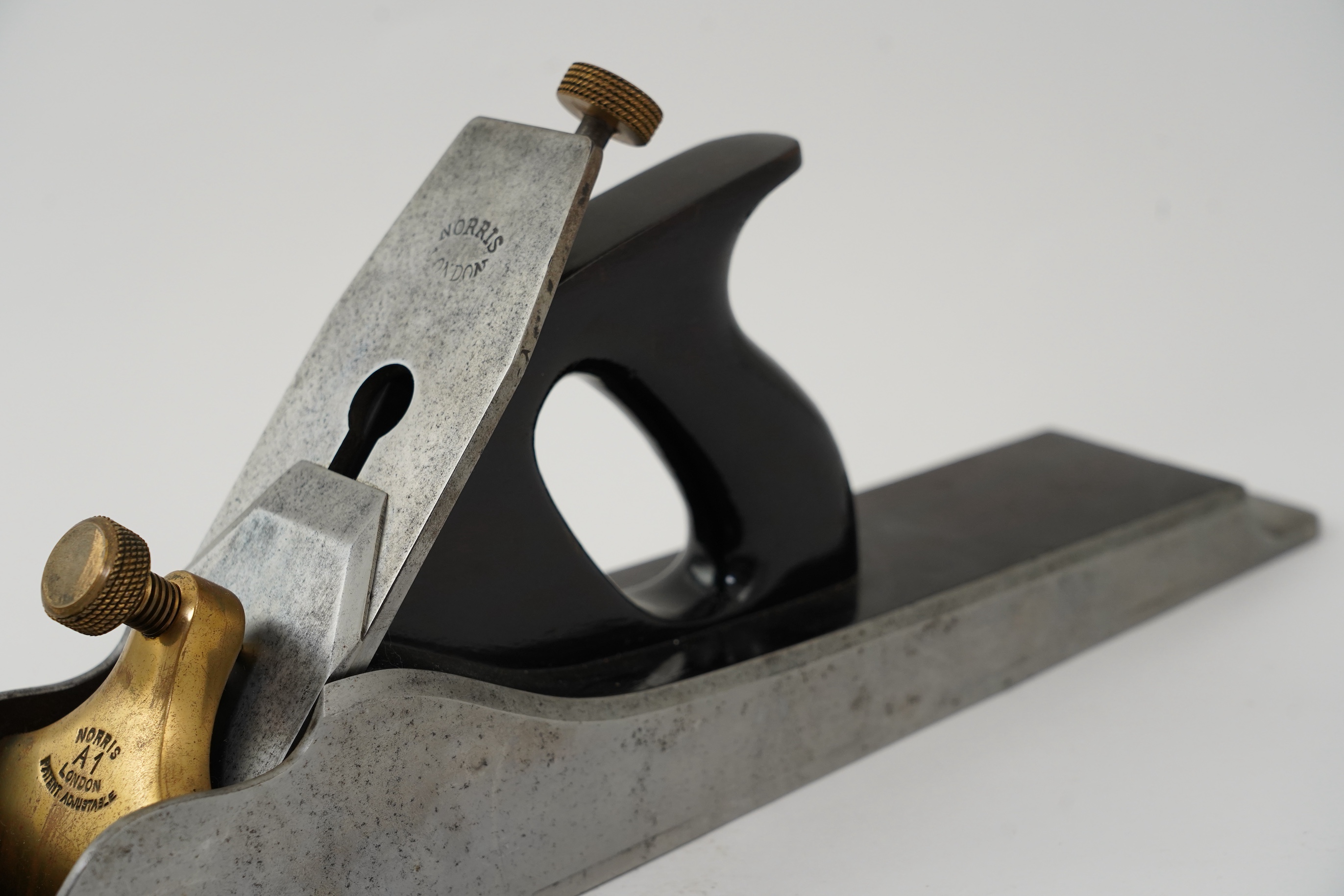 A Norris A1 adjustable 22 1/2” jointer plane with rosewood infill and handle, stamped with Norris, London to both the brass lever cap and the iron